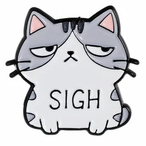 Close-up of a cartoon cat enamel pin with SIGH engraving and grey metal details