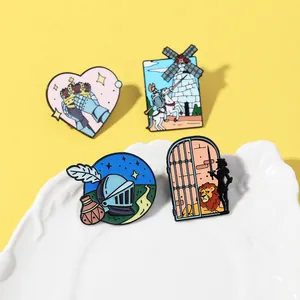 Enamel knight-themed brooch set with crown and windmill designs on yellow background