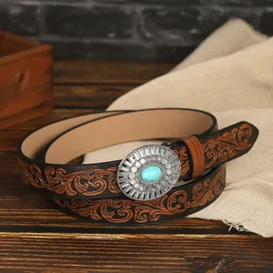 Detail of vintage embossed leather belt with oval buckle and turquoise stone inlay
