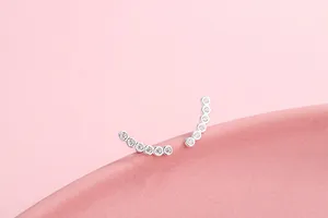 Close-up of curved S925 silver ear crawlers with seven sparkling round cubic zirconia stones