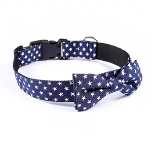 Detail of navy blue cotton dog collar with white star print and black plastic buckle