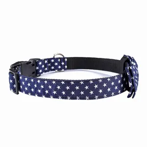 Detail of navy blue cotton dog collar with white stars, bow tie and quick release buckle