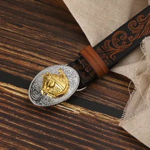 Detail of vintage belt with western style oval buckle and gold horse head relief