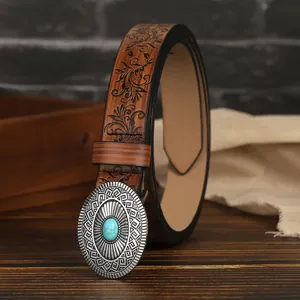 Macro detail of western retro leather belt with floral embossing and turquoise buckle