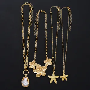 Detailed view of four gold-plated necklaces featuring baroque pearls, starfish, and flowers