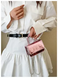 Detail of mini pink metallic faux crocodile skin handbag with silver bead chain
