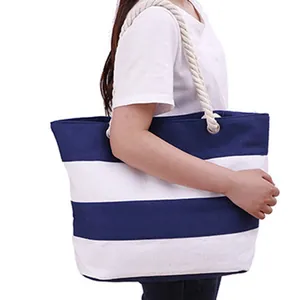 Classic blue and white striped canvas tote bag with thick white rope handles for beach travel