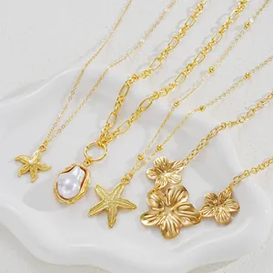 Close-up of gold starfish and pearl necklace set on a decorative white shell tray