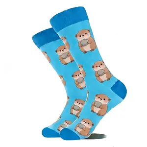 Close-up of sky blue crew socks featuring cute cartoon otter patterns with navy blue heels