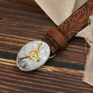 Close-up of western style leather belt with floral engraved buckle and golden bull head