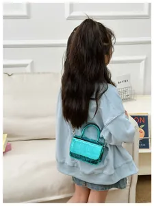 Detail of mini crocodile embossed PU leather crossbody bag in glossy Tiffany blue for girls