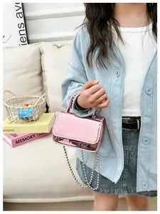 Detail of metallic pink crocodile pattern mini handbag with silver bead chain strap
