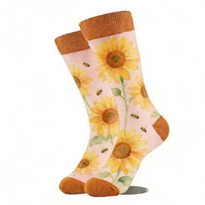 Detail of pink crew socks featuring yellow rib cuffs and vibrant sunflower bee patterns