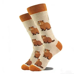 Close-up of crew socks featuring pixelated capybara patterns and orange ribbed cuffs