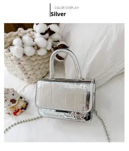 Detail of silver mini tote bag with crocodile texture and metal ball chain strap