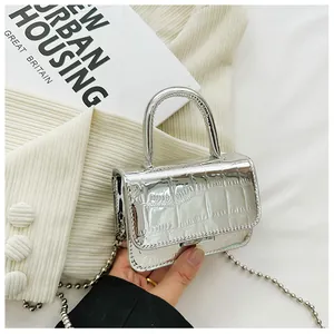 Detailed close-up of a mini silver metallic bag with crocodile texture and bead chain
