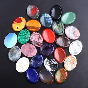 Flat lay of diverse oval-shaped polished natural crystal palm stones and gemstones
