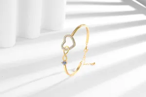 Macro detail of infinity heart bracelet with gold plating, lobster clasp and extension chain