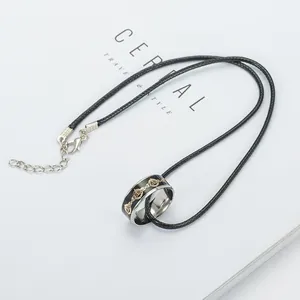 Detail of creative ring pendant necklace with black woven rope and adjustable lobster clasp