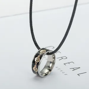 Detail of gaming ring pendant with black enamel finish on a woven leather cord