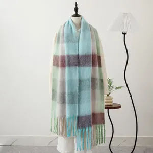 Detail of soft mohair plaid scarf featuring long tassels and pastel checkered pattern