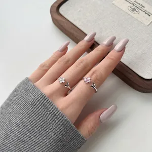 Detail of s925 silver open rings featuring cherry blossom and butterfly with pink zircon