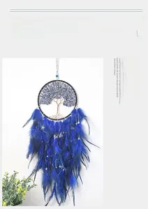 Detail of life tree dreamcatcher with blue crushed stones and hanging soft feathers