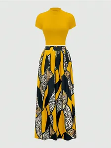 Detailed view of the yellow high-neck crop top and baroque leopard print wide-leg trousers