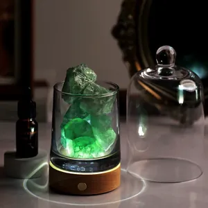 Detail of green fluorite diffuser lamp with wooden LED base and aromatic oil bottle