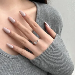 Close-up of S925 silver flower ring with sparkling zircon petals on a model finger