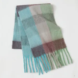 Close-up of checkered scarf showing colorful mohair texture and long fringe tassels