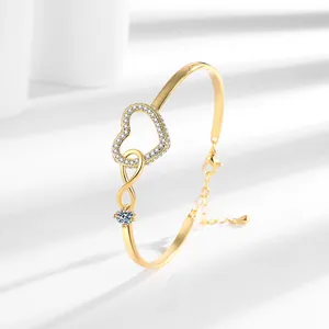 Gold infinity heart bracelet with cubic zirconia inlays and adjustable lobster clasp