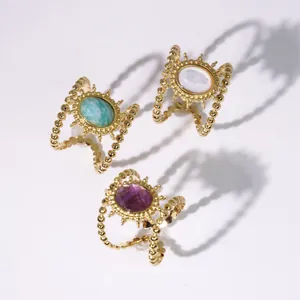 Retro sunflower rings with natural stones and gold beaded bands on white background