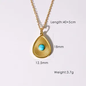 Detailed macro view of 14K gold teardrop pendant necklace with turquoise stone inlay