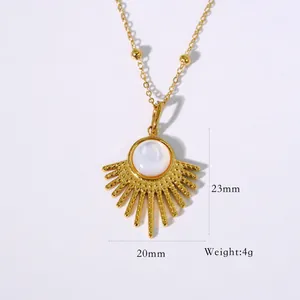 Detailed view of sunburst gold pendant necklace with white stone inlay and bead chain