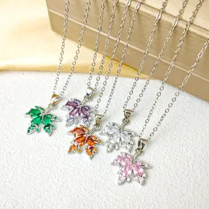 Exquisite maple leaf pendant necklaces with colorful rhinestones on a silk background