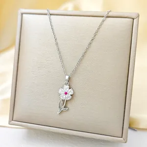 Sunflower necklace with pink zircon and red center stone on champagne jewelry box