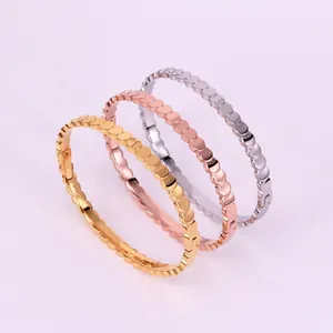 Three-tone stackable beaded fish-scale bracelets in gold, silver, and rose gold finish