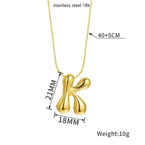 Detailed view of golden 3D balloon letter K pendant with size and material specifications