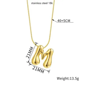 3D bubble letter M pendant necklace in 18k gold plated stainless steel on white background