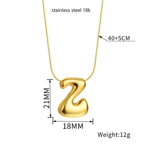 Macro shot of polished gold balloon letter Z pendant with detailed size and weight specs