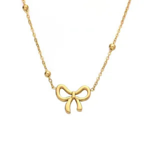 Golden titanium steel bow pendant necklace with bead accents on a minimalist chain
