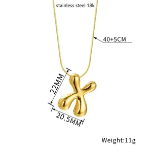 Polished 18K gold plated stainless steel balloon X initial pendant necklace on white background