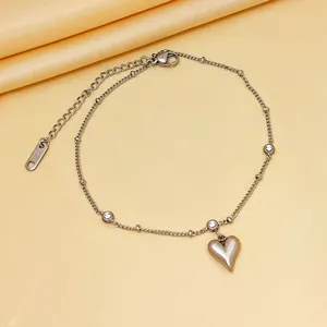 Detailed macro view of silver titanium steel heart anklet with small diamonds