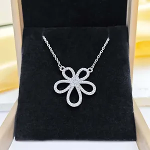 Macro shot of silver flower pendant with sparkling zircon in black jewelry box