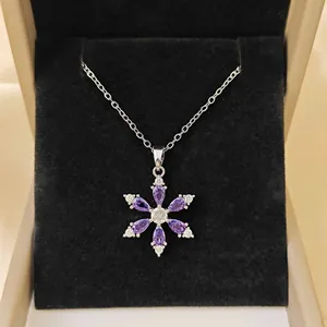 Snowflake pendant necklace with purple marquise zircons in a premium jewelry gift box