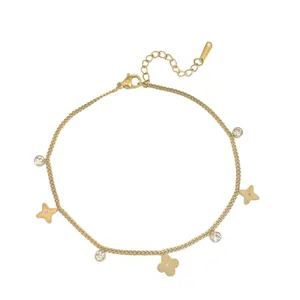 Golden stainless steel bracelet with clover charms and clear crystal stones on white background