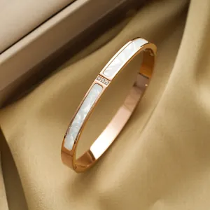 Rose gold titanium steel bracelet with white shell inlay on champagne satin background