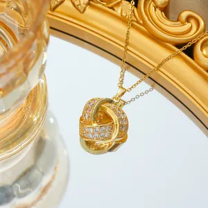 Luxurious gold necklace with sparkling twisted knot pendant featuring pavé-set zircons