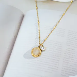 Detail of titanium steel cat eye necklace with gold satellite chain and zircon charm